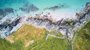 Preview wallpaper rocks, sea, grass, aerial view