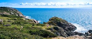 Preview wallpaper rocks, sea, horizon, bushes, clouds