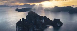Preview wallpaper rocks, sea, rays, distance