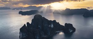 Preview wallpaper rocks, sea, rays, distance