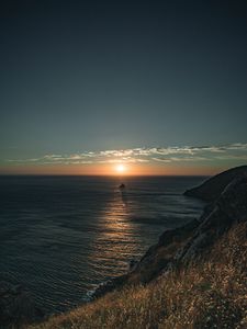 Preview wallpaper rocks, sea, sunset, sun, slope, grass