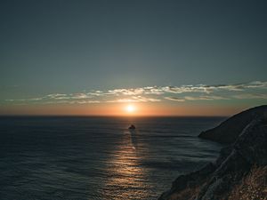 Preview wallpaper rocks, sea, sunset, sun, slope, grass