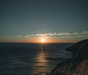 Preview wallpaper rocks, sea, sunset, sun, slope, grass