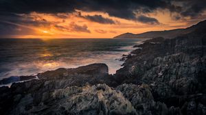 Preview wallpaper rocks, sea, sunset, stones, clouds, sky