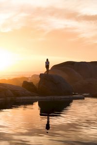 Preview wallpaper rocks, silhouette, sunset, water, south africa