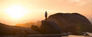 Preview wallpaper rocks, silhouette, sunset, water, south africa