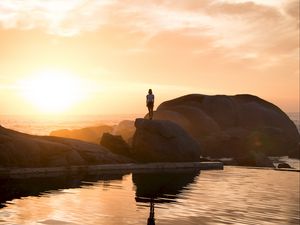 Preview wallpaper rocks, silhouette, sunset, water, south africa