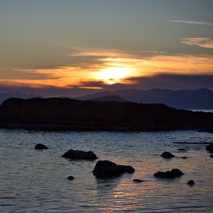 Preview wallpaper rocks, silhouettes, sea, sunset, dark