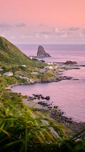Preview wallpaper rocks, slope, coast, grass, sunset