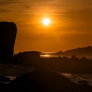 Preview wallpaper rocks, stones, sea, sun, dark