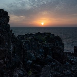 Preview wallpaper rocks, stones, sunset, sun, ocean