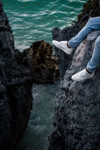 Preview wallpaper rocks, water, legs, sneakers, shore