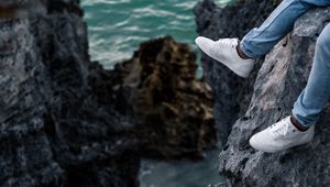 Preview wallpaper rocks, water, legs, sneakers, shore