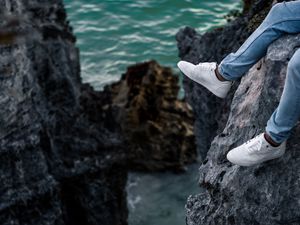 Preview wallpaper rocks, water, legs, sneakers, shore