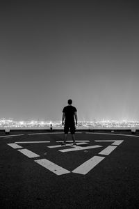 Preview wallpaper roof, loneliness, bw, man, night city, top view