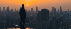 Preview wallpaper roof, man, city, sunset, buildings, overview