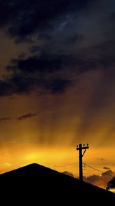 Preview wallpaper roof, pillar, silhouettes, sunset, dark, rays