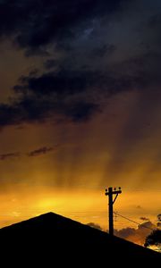 Preview wallpaper roof, pillar, silhouettes, sunset, dark, rays