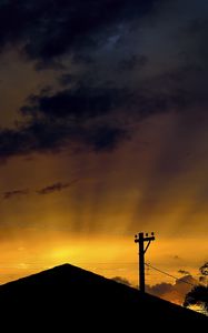 Preview wallpaper roof, pillar, silhouettes, sunset, dark, rays