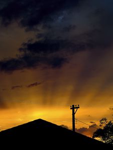 Preview wallpaper roof, pillar, silhouettes, sunset, dark, rays