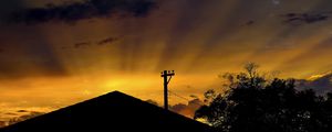 Preview wallpaper roof, pillar, silhouettes, sunset, dark, rays