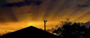 Preview wallpaper roof, pillar, silhouettes, sunset, dark, rays