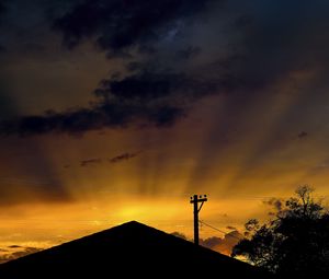 Preview wallpaper roof, pillar, silhouettes, sunset, dark, rays