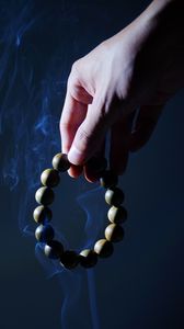 Preview wallpaper rosary, hand, smoke