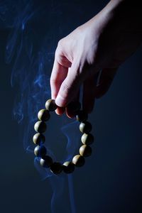 Preview wallpaper rosary, hand, smoke