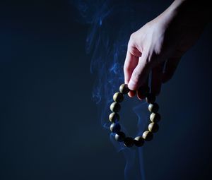 Preview wallpaper rosary, hand, smoke