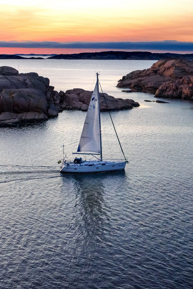 Download wallpaper 800x1200 boat, sail, sea, stones, sunset, horizon ...