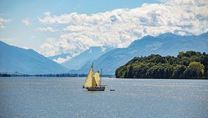 Preview wallpaper sailboat, boat, sea, hills, sky