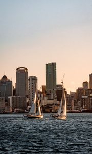 Preview wallpaper sailboat, city, buildings, skyscrapers, water