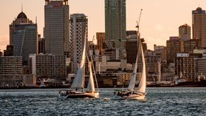 Preview wallpaper sailboat, city, buildings, skyscrapers, water