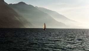 Preview wallpaper sailboat, sea, mountains, fog, waves