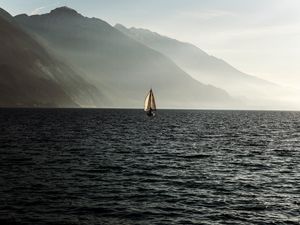 Preview wallpaper sailboat, sea, mountains, fog, waves