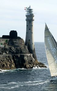 Preview wallpaper sailing vessel, rock, beacon, sea, excursion, tourists