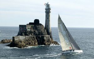 Preview wallpaper sailing vessel, rock, beacon, sea, excursion, tourists