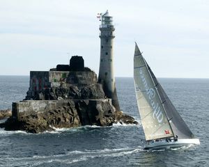 Preview wallpaper sailing vessel, rock, beacon, sea, excursion, tourists