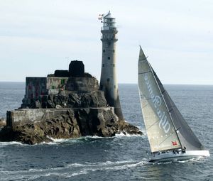 Preview wallpaper sailing vessel, rock, beacon, sea, excursion, tourists