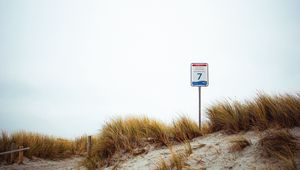 Preview wallpaper sand, grass, sign, hill