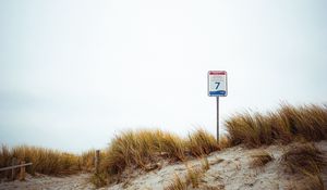 Preview wallpaper sand, grass, sign, hill