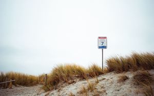 Preview wallpaper sand, grass, sign, hill