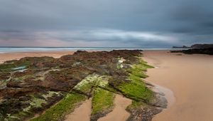 Preview wallpaper sand, plates, moss, coast, sea, cloudy