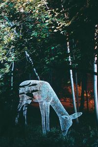 Preview wallpaper sculpture, light, trees, deer, art