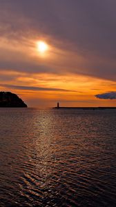 Preview wallpaper sea, bay, lighthouse, mountains, sunset, clouds, sun