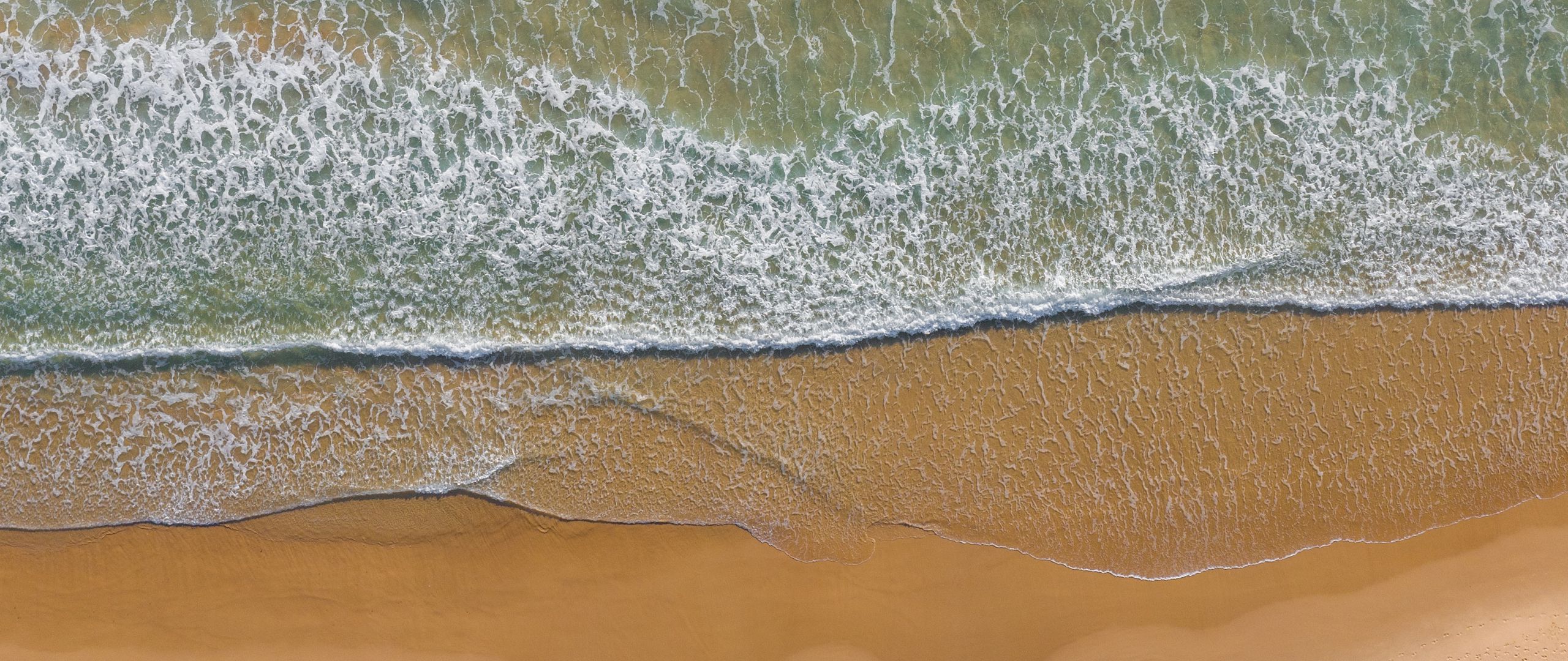 Download wallpaper 2560x1080 sea, beach, aerial view, wave, surf, water