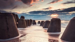 Preview wallpaper sea, beach, breakwaters, water, sand, sunset