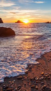 Preview wallpaper sea, beach, pebbles, rocks, sunset