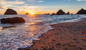 Preview wallpaper sea, beach, pebbles, rocks, sunset